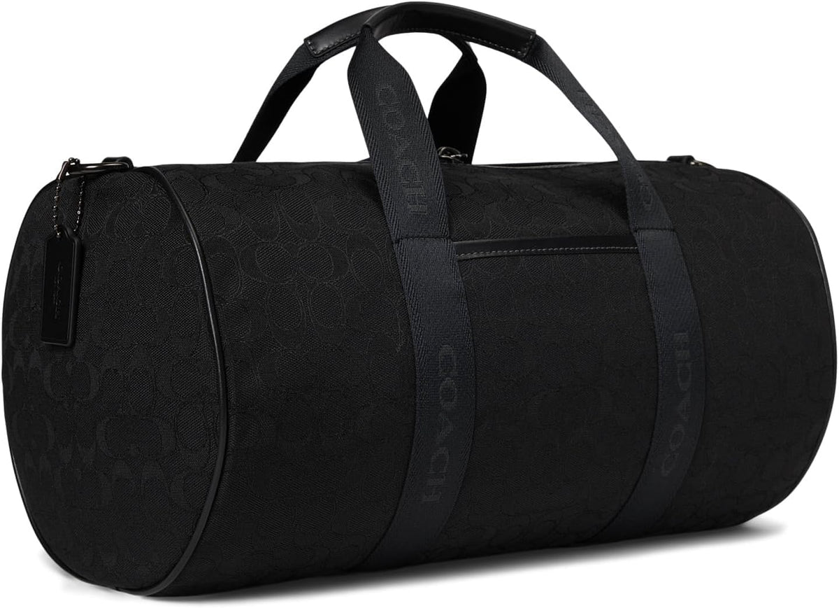 Coach Theo Duffle Premium Signature Jacquard black, stylish travel bag with sturdy handles.